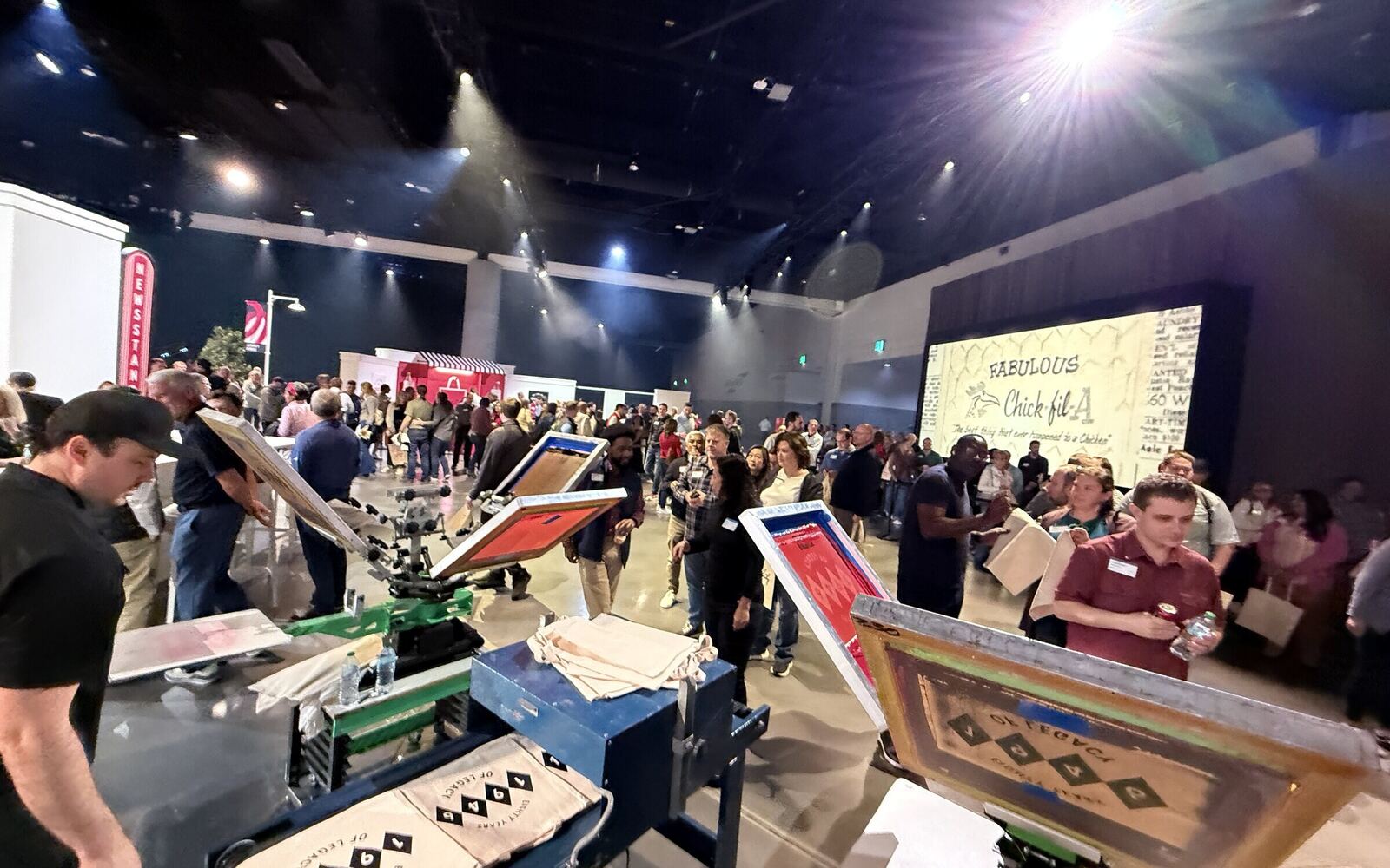 Custom company t-shirt being printed at a corporate event booth
